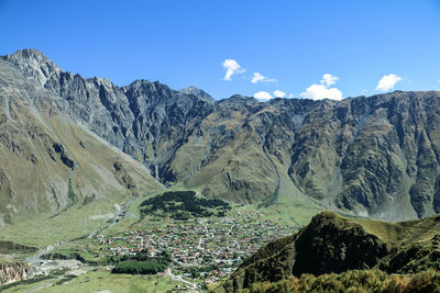 Panoramic view of mountains against blue sky
