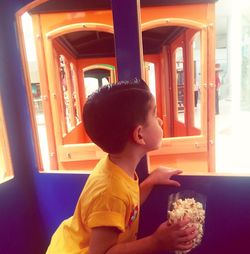 Cute boy sitting on chair