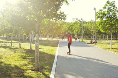 Full length of people walking on footpath in park