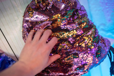 High angle view of woman with shiny bag on table