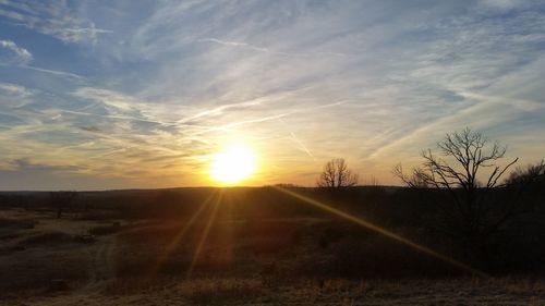 Scenic view of field against sky during sunset