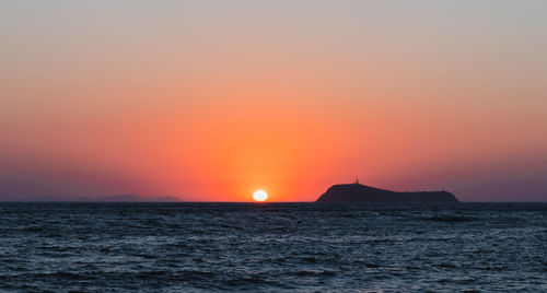 Scenic view of sea against romantic sky at sunset