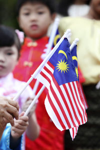 Cute friends holding malaysia flags