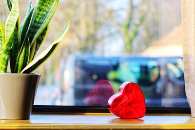 Close-up of glass vase on window sill