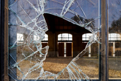 Broken glass window of abandoned building