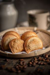 Fried curry puffs on a rattan plate. malaysian snacks. malaysian breakfast. asian foods.