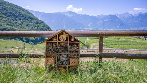 Insect hotel on field against mountains