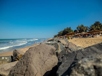 Scenic view of beach against clear blue sky