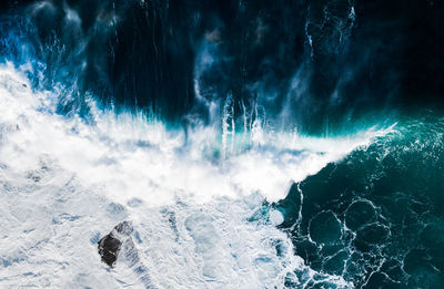 Aerial view of waves breaking against the coast