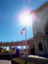 Low angle view of flags against clear sky