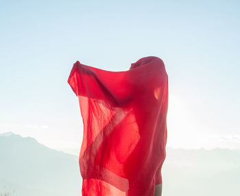 Low angle view of woman standing against clear sky