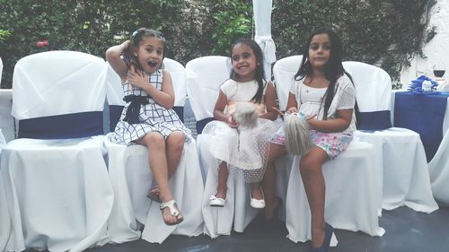 Portrait of happy girls sitting outdoors