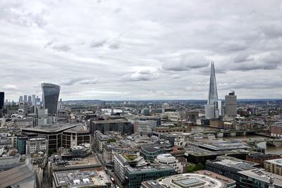 Aerial view of buildings in city  of london against cloudy sky