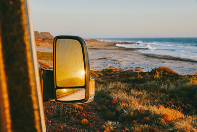 Sunset reflected in side mirror of camper van in baja, mexico.