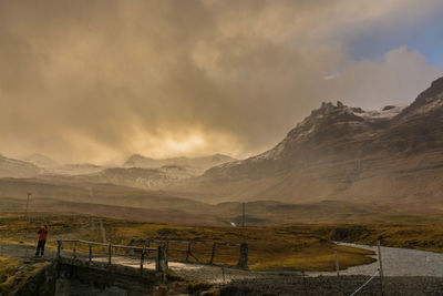 Scenic view of mountains against cloudy sky