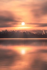 Scenic view of lake against sky during sunrise