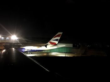 Airplane in illuminated city at night