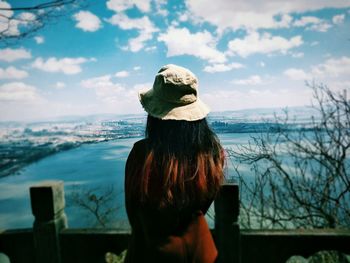 Rear view of woman looking at sea against sky