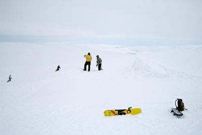 People skiing on snow covered mountain