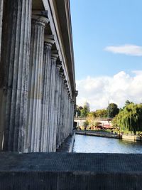 Built structure by bridge against sky