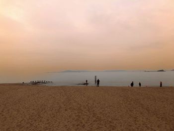 Scenic view of beach against sky during sunset