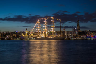 Illuminated commercial dock against sky at night