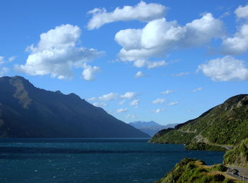 Scenic view of sea and mountains against sky