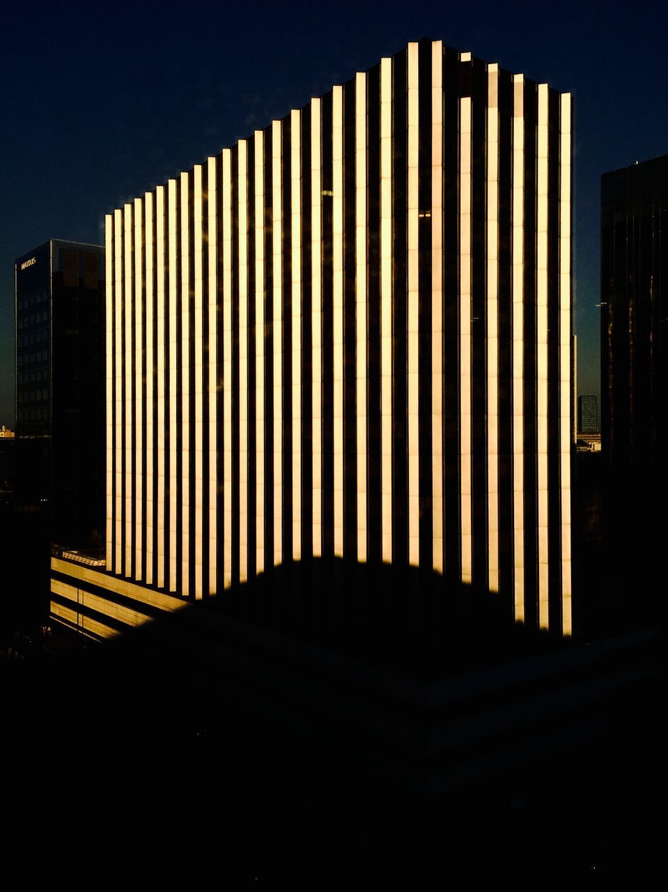 building exterior, architecture, built structure, city, skyscraper, modern, office building, illuminated, building, tall - high, night, sky, tower, no people, outdoors, silhouette, clear sky, low angle view, city life, dusk