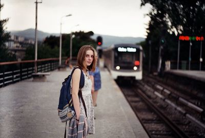 Woman on railroad station platform in city