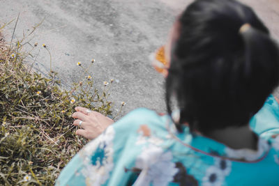 High angle portrait of woman holding plant