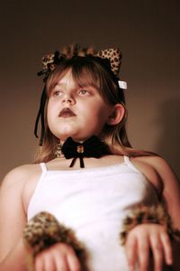Portrait of serious girl wearing feline costume