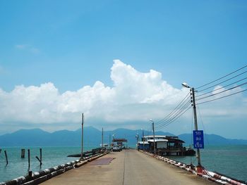Panoramic view of bridge over sea against blue sky