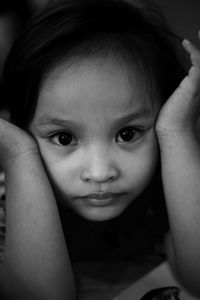 Close-up portrait of girl with head in hands