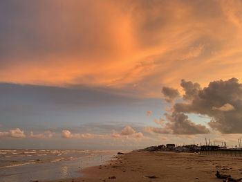 Scenic view of beach against sky during sunset