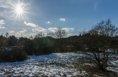 Scenic view of snow covered landscape against sky