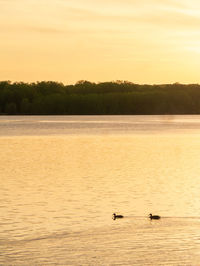 Scenic view of lake against sky during sunset