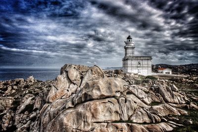 Lighthouse against cloudy sky