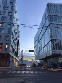 View of city street and buildings against sky