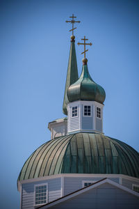 Low angle view of building against clear blue sky