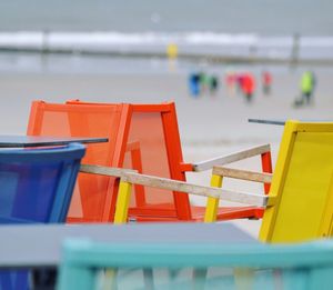 Close-up of chairs on beach