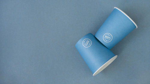 High angle view of paper on table against blue background