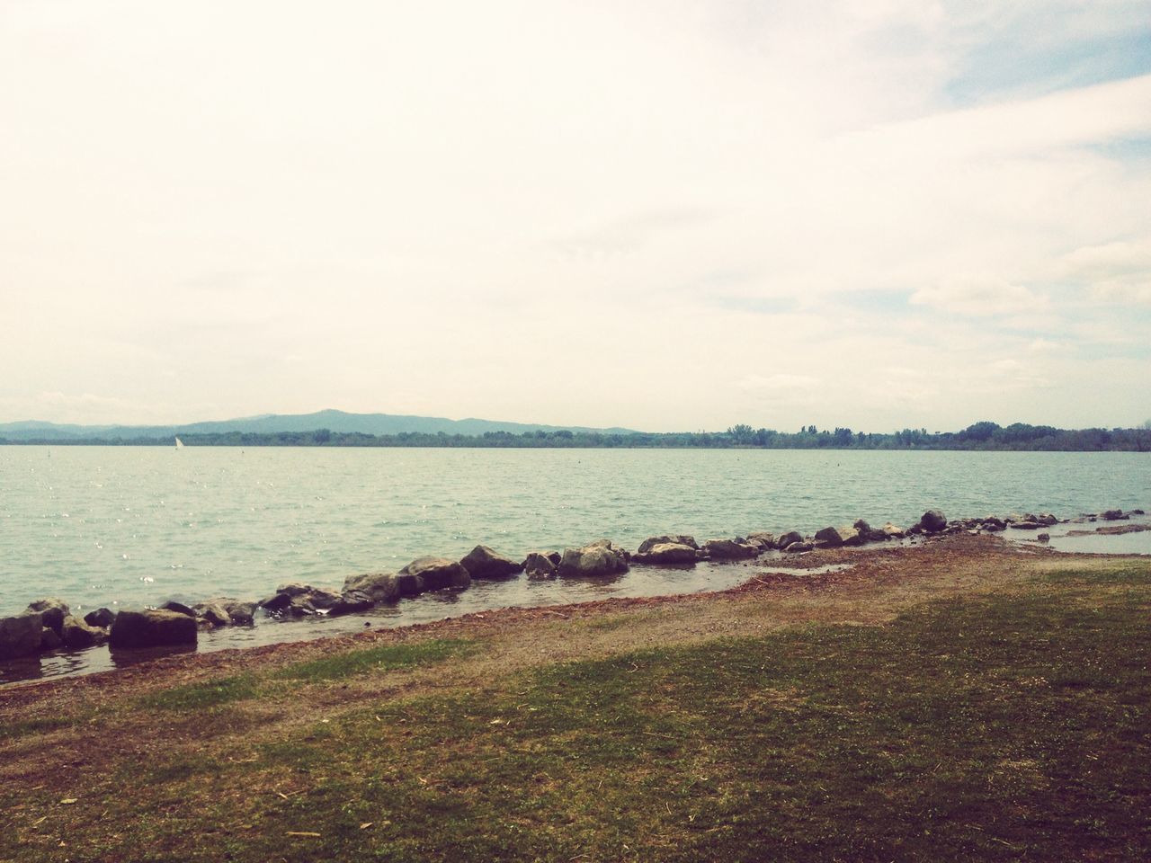 water, sky, tranquil scene, tranquility, scenics, nature, beauty in nature, sea, lake, landscape, rock - object, river, cloud - sky, idyllic, shore, non-urban scene, day, beach, outdoors, lakeshore