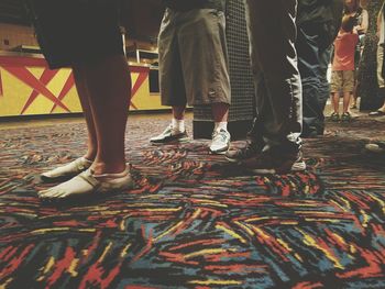 Low section of woman standing on tiled floor