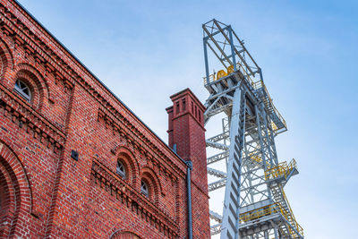 Mine shaft tower 'krystyn' in former coal mine 'michal' in siemianowice, silesia, against blue sky. 