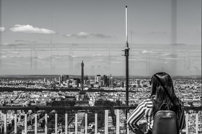 Rear view of woman looking at cityscape