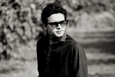 Young man wearing sunglasses standing outdoors