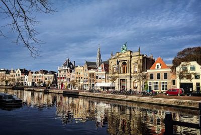 River by buildings against sky in city