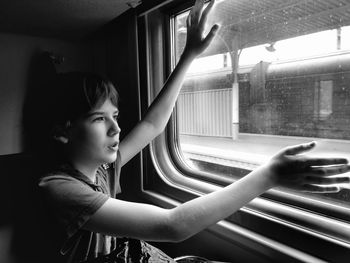 Portrait of girl looking through window