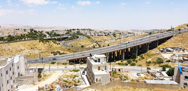 High angle view of road by bridge in city against sky