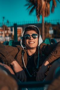 Portrait of smiling young man relaxing on chair